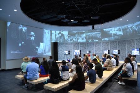 Visitors gather at the welcome center of Holocaust Museum Houston, one of five local museums that are participating in a national program to increase diversity and inclusion in their governing boards.