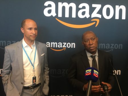 Houston Mayor Sylvester Turner, right, and Kris Satterthwaite, enterprise sales leader at AWS Gulf Coast, talk to reporters during the grand opening of Houston's Amazon tech hub.