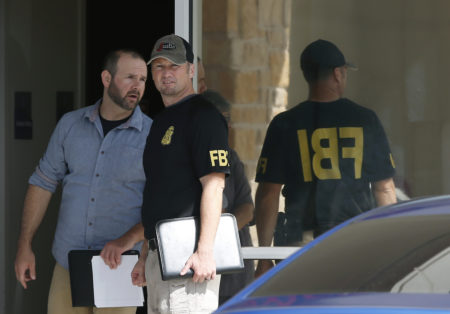 Law enforcement officials investigate Saturday's shooting at a shopping center Sunday, Sept. 1, 2019, in Odessa, Texas.