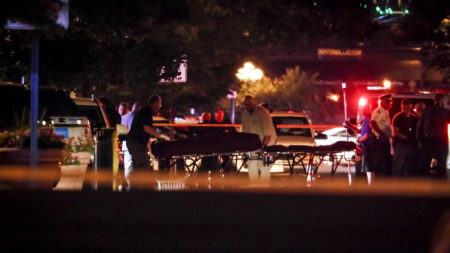 Bodies are removed from the scene of a mass shooting in Dayton, Ohio, Sunday.