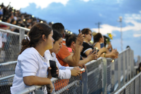 Members of the El Paso community pack the Horizon High School football stadium Monday for a vigil to honor 15-year-old Javier Amir Rodriguez, who died in a mass shooting Saturday.