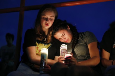 Melody Stout and Hannah Payan comfort each other during a vigil Saturday night for victims of the El Paso shooting.