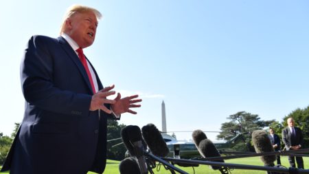 President Trump speaks to the press on the South Lawn of the White House Friday. He called for background checks amid pressure to act on gun legislation.