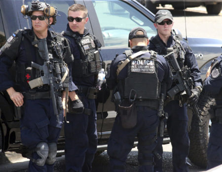 U.S. Customs and Border Protection officers gather near the scene of a shooting at a shopping mall in El Paso, Texas, on Saturday, Aug. 3, 2019.   Multiple people were killed and one person was in custody after a shooter went on a rampage at a shopping mall, police in the Texas border town of El Paso said.