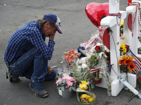 Antonio Basco cries beside a memorial near the scene of the recent mass shooting in El Paso, Texas. Basco, whose 63-year-old wife was among the victims, says he has no other family and welcomes anyone wanting to attend her funeral service.