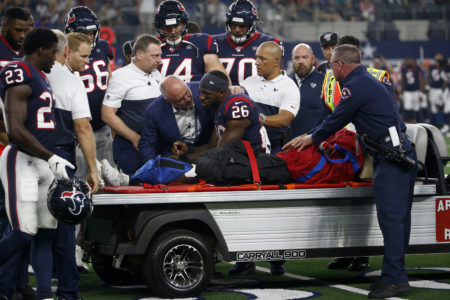 Houston Texans' Lamar Miller (26) is assisted by team staff and first responders after suffering an unknown injury during a preseason NFL football game against the Dallas Cowboys in Arlington, Texas, Saturday, Aug. 24, 2019.