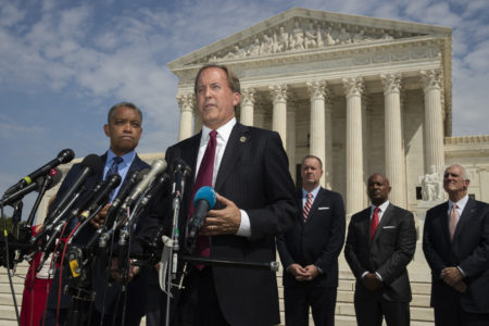 Texas Attorney General Ken Paxton, center, with District of Columbia Attorney General Karl Racine, left, and a bipartisan group of state attorneys general speaks to reporters in front of the U.S. Supreme Court in Washington, Monday, Sept. 9, 2019 on an antitrust investigation of big tech companies.
