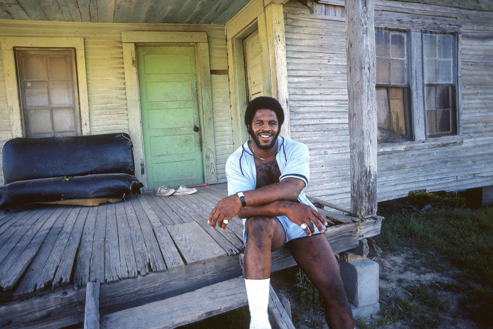 Football running back Earl Campbell poses in his Houston Oilers