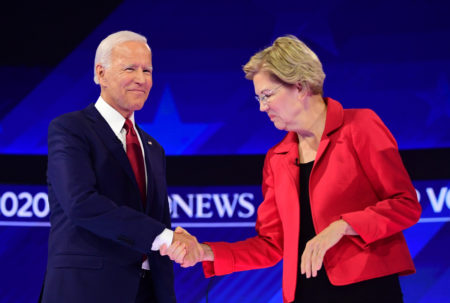 Democratic presidential hopefuls Massachusetts Sen. Elizabeth Warren and Former Vice President Joe Biden shake hands as they arrive on the debate stage.