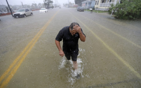 Angel Marshman wades through floodwaters from Tropical Depression Imelda after trying to start his flooded car Wednesday, Sept. 18, 2019, in Galveston, Texas.