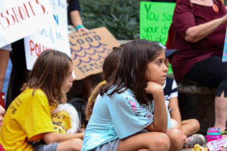 Children listen to speakers at the climate change rally outside City Hall.