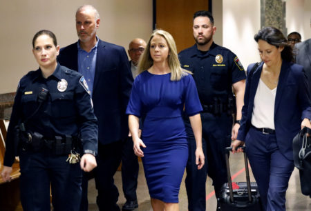 Former Dallas police officer Amber Guyger, center, arrives for the first day of her murder trial in the 204th District Court at the Frank Crowley Courts Building in Dallas, Monday, Sept. 23, 2019. Guyger is accused of shooting her black neighbor in his Dallas apartment.