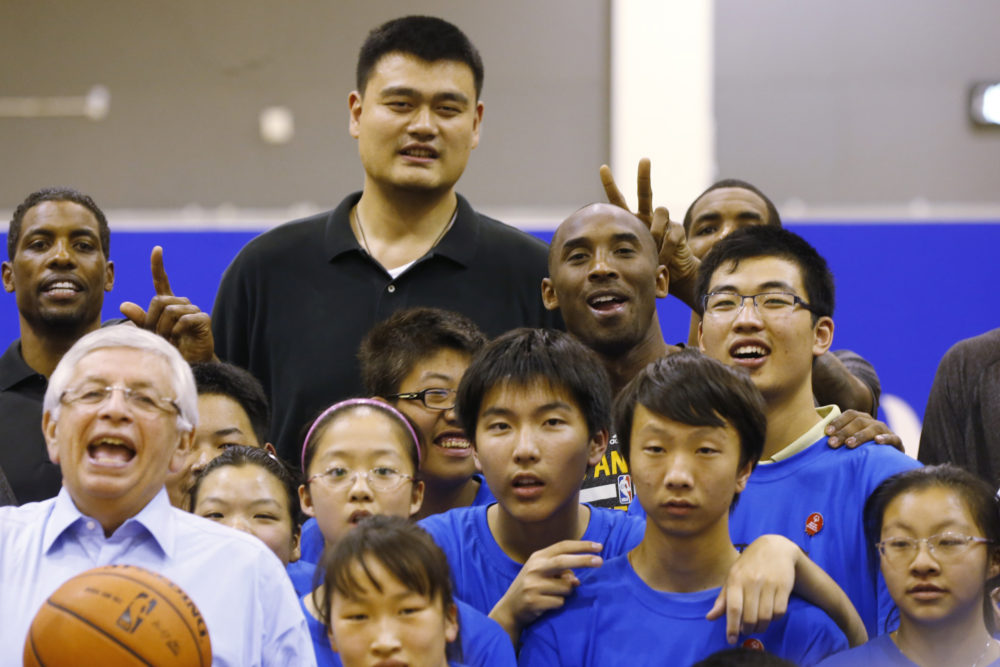 In this [photo from Oct. 2013, Kobe Bryant of the Los Angeles Lakers, top row center right, former NBA Houston Rockets basketball player Yao Ming, top row center left, and NBA Commissioner David Stern, bottom left pose with children during the NBA Cares Special Olympics Basketball Clinic ahead of a 2013-2014 NBA preseason game against the Golden State Warriors in Shanghai, China.  Houston Rockets general manager Daryl Morey tried Sunday, Oct. 6, 2019 to defuse the rapidly growing fallout over his deleted tweet that showed support for Hong Kong anti-government protesters, saying he did not intend to offend any of the team's Chinese fans or sponsors. 