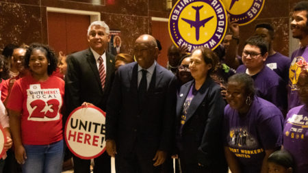 Mayor Turner with UNITE HERE and Airport Workers United in City Hall after signing executive order to increase minimum wages for airport workers to $12 an hour.