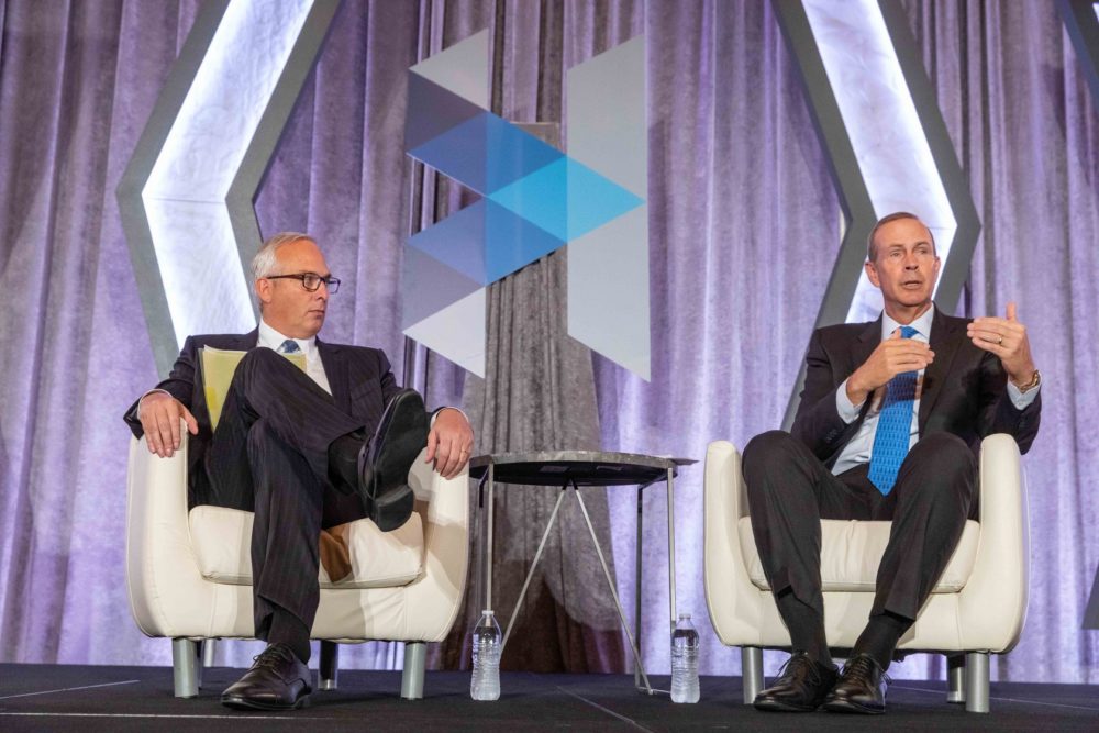 Chevron CEO Michael Wirth, right, chats with Bobby Tudor, chairman of Tudor, Pickering, Holt and Co., at the Greater Houston Partnership's annual State of Energy event on Wednesday, Oct. 9, 2019.