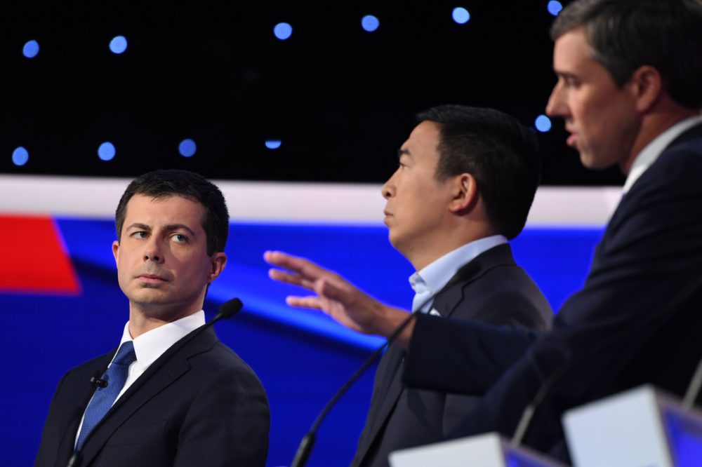 Democratic presidential hopeful Pete Buttigieg, mayor of South Bend, Ind., (left) and entrepreneur Andrew Yang (center) listen as former Texas Rep. Beto O'Rourke speaks during the fourth Democratic primary debate.