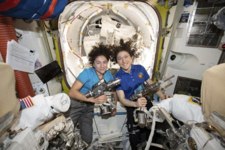 In this photo released by NASA on Thursday, Oct. 17, 2019, U.S. astronauts Jessica Meir, left, and Christina Koch pose for a photo in the International Space Station. On Friday, Oct. 18, 2019, the two performed the first all-female spacewalk in history replacing a broken battery charger.