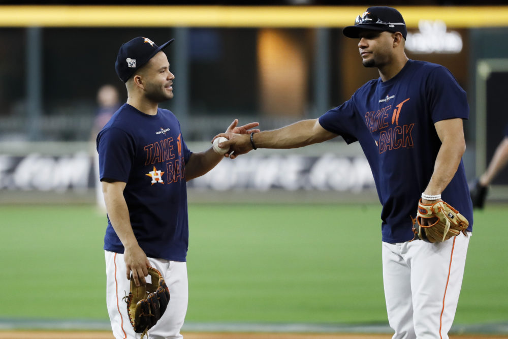 Houston Astros second baseman Jose Altuve, left, and first baseman Yuli Gurriel talk during a practice day for baseball's World Series Monday, Oct. 21, 2019, in Houston. The Houston Astros face the Washington Nationals in Game 1 on Tuesday.