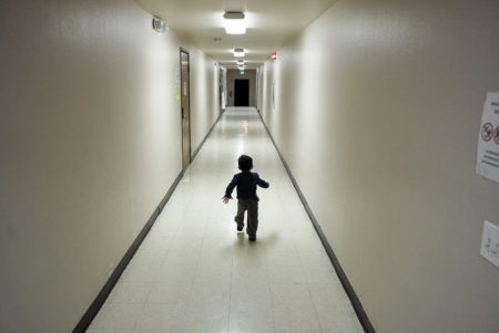 In this Dec. 11, 2018 file photo, an asylum-seeking boy from Central America runs down a hallway after arriving from an immigration detention center to a shelter in San Diego. The American Civil Liberties Union says on Thursday, Oct. 24, 2019, U.S. immigration authorities separated more than 1,500 children from their parents at the Mexico border early in the Trump administration, bringing the total number of children separated since July 2017 to more than 5,400.
