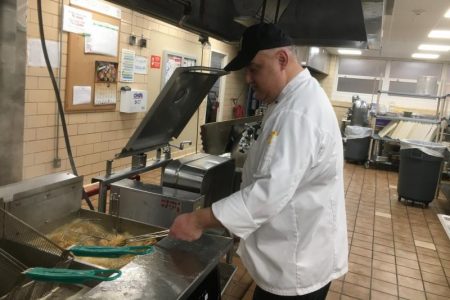 Rudy Vasquez fries up some chicken tenders breaded with flour is gluten free. He says they experimented with a number of different flour blends to find the right balance.
