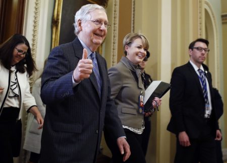 Senate Majority Leader Mitch McConnell, R-Ky., gives a thumbs up as he leaves the Senate chamber during the impeachment trial of President Trump on Friday.