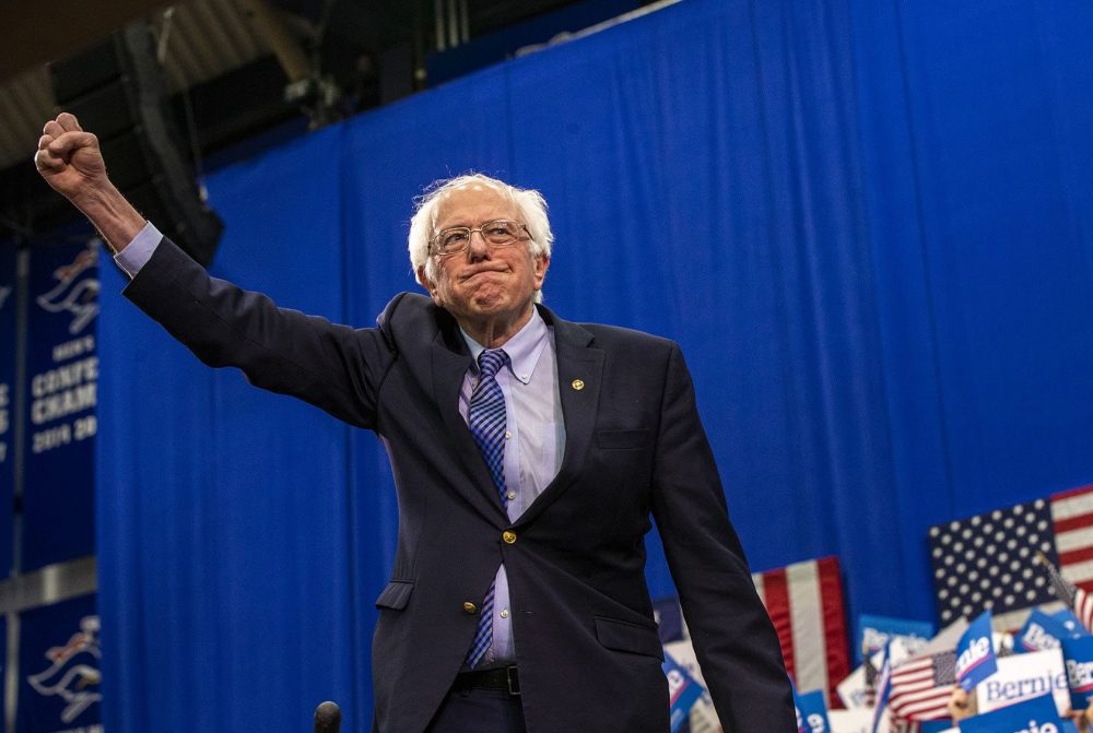 Bernie Sanders raises his fist in victory after the New Hampshire primary. Sanders is in the pole position for the Democratic nomination.