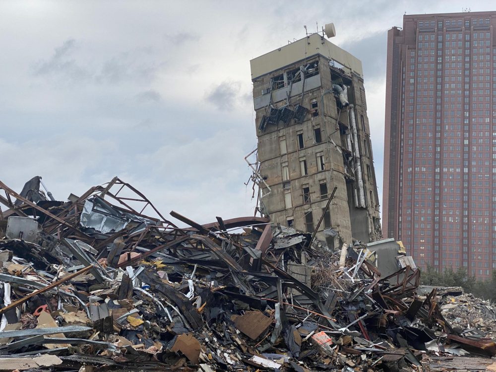 A failed implosion last week left a large chunk of the former Affiliated Computer Services building still standing — and leaning.