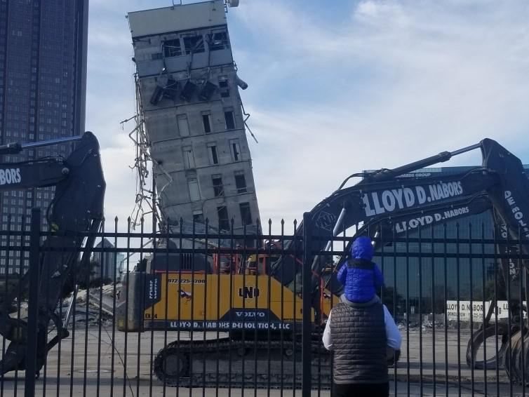 James looks at the leaning tower from his dad James' shoulders before demolition begins.