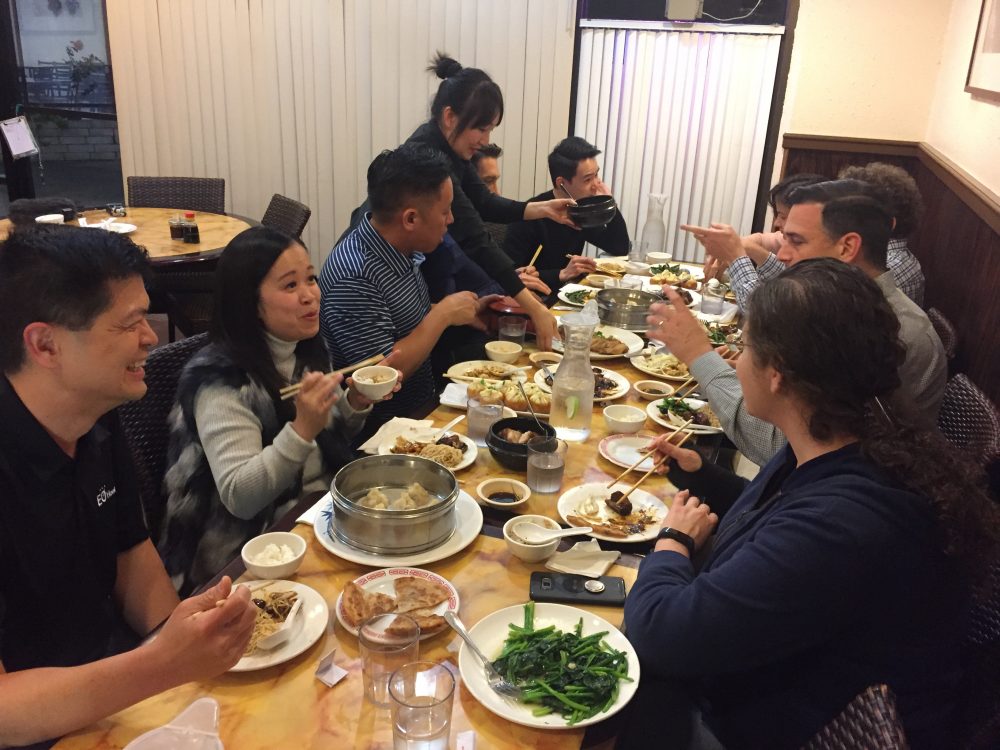 Members of the Entrepreneurs' Organization have dinner at One Dragon Restaurant in Chinatown. But restaurant owners say Chinese families have stopped dining because of rumors spread on Chinese social media.