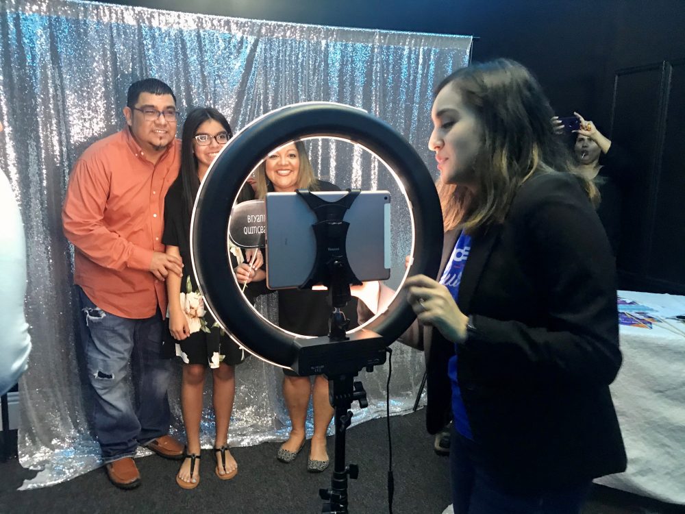 Jolt Initiative's Keyli Sandoval runs the photo booth next to a voter registration table at a quinceañera in Pasadena, Texas.