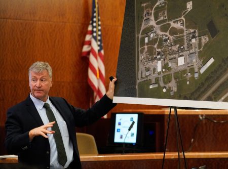Special prosecutor Michael Doyle holds up a map of Arkema's Crosby plant during his opening statement,