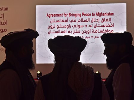 Members of the Taliban delegation gather ahead of Saturday's signing ceremony with the United States in the Qatari capital of Doha.