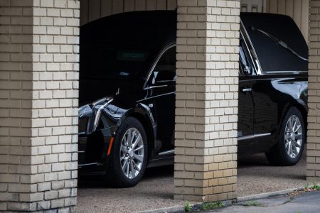 A hearse is parked outside Mission Funeral Home. Funeral homes in Austin must comply with local and statewide orders that limit how many people can gather during the coronavirus pandemic.