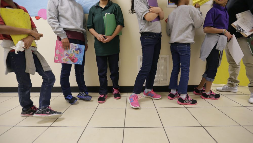 Migrant teens line up for a class at a "tender-age" facility for babies, children and teens, in Texas' Rio Grande Valley, Thursday, Aug. 29, 2019, in San Benito, Texas.