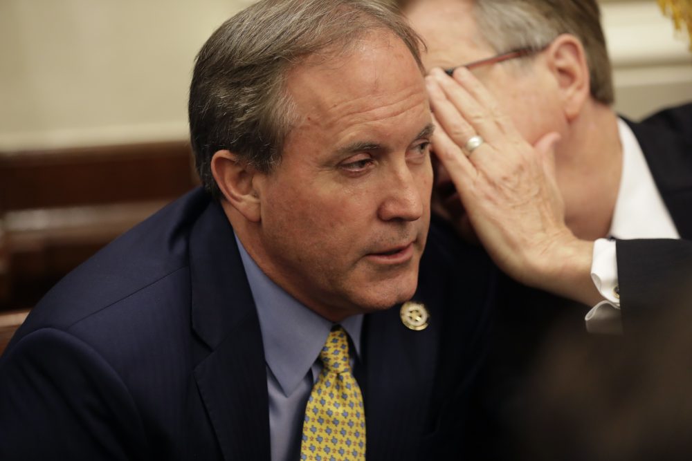 Texas Attorney General Ken Paxton, left, listens to Lt. Gov. Dan Patrick during a roundtable discussion in 2018.