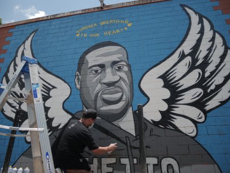 Graffiti artist Donkeeboy puts the finishing touches on a mural in honor of former Houstonian George Floyd, on Tuesday, June 2.