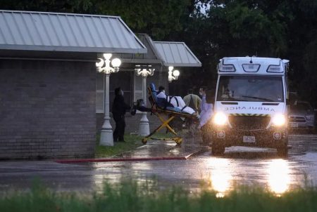 Healthcare workers transport a patient on a stretcher from the Southeast Nursing and Rehabilitation Center nursing home in San Antonio. April 4, 2020.