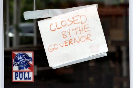 A sign on the door of the West Alabama Icehouse reads "Closed by the Governor", Monday, June 29, 2020, in Houston. Texas Gov. Greg Abbott shut down bars again and scaled back restaurant dining on Friday as cases climbed to record levels after the state embarked on one of America's fastest reopening.
