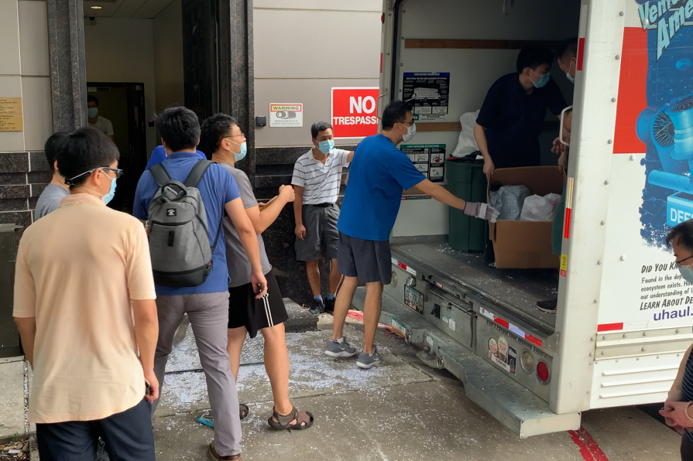 Workers load a moving van outside the Chinese consulate in Houston, on July 24, 2020.