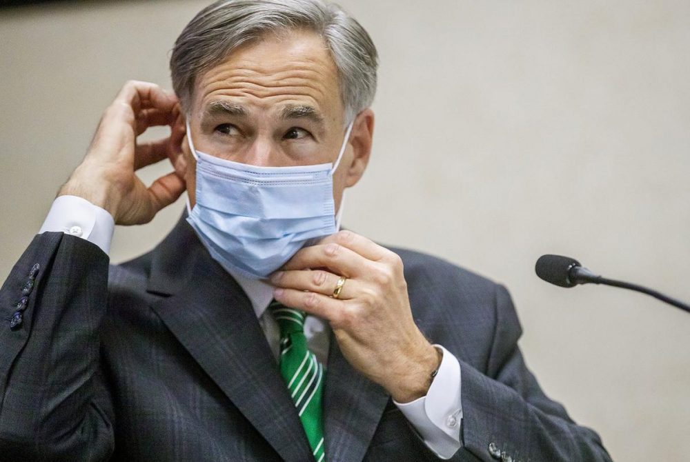 Gov. Greg Abbott adjusts his mask after giving an update on the categories of medical surge facilities at a press conference at the Texas Department of Public Safety on Tuesday, June 16, 2020.