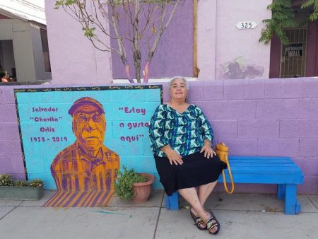 Chicana historian Yolanda Chavez Leyva sits outside one of the remaining homes in Duranguito, one of El Paso's oldest neighborhoods.