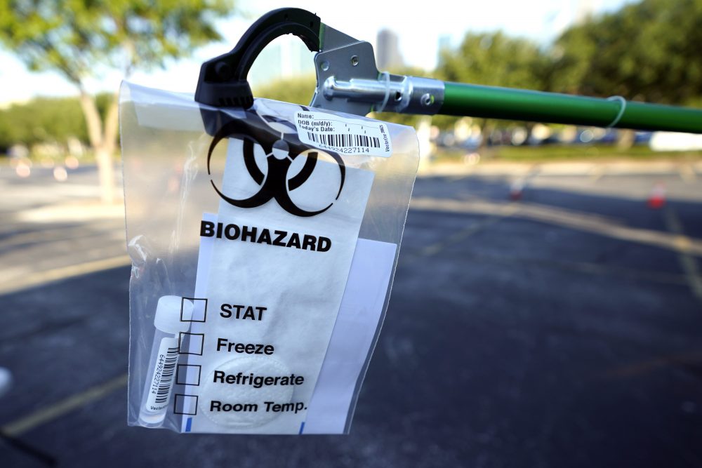 A test kit is displayed at a Texas Division of Emergency Management free COVID-19 testing site at Minute Maid Park Saturday, Aug. 8, 2020, in Houston. The newly opened mega site, which has eight drive-thru lanes and four walk-up lanes, has the ability to process 2,000 tests per day.