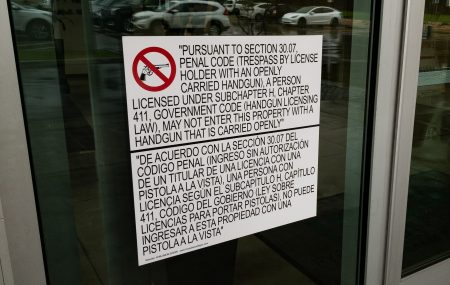 A "30.07" sign on a building in Austin, Texas, prohibits open carry of guns: "Pursuant to Section 30.07, Penal Code (Trespass by License Holder with an Openly Carried Handgun), a person licensed under Subchapter H, Chapter 411, Government Code (Handgun Licensing Law), may not enter this property with a handgun that is carried openly"