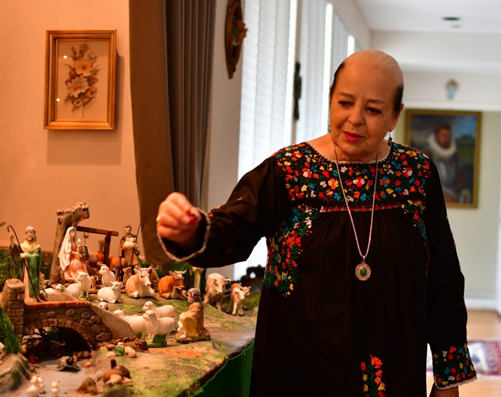 Dorothy Caram shows pieces she's collected for the Christmas nativity she has on display at her Houston home. 