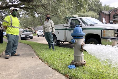 City workers Kristina Watson, right, and Lennie Miner, a maintenance foreman monitor Monday, Sept. 28, 2020, test water flowing out of a hydrant in Lake Jackson, Texas. The city remains under a boil water advisory after a deadly microbe was found to have caused the death of a 6-year-old boy exposed to contaminated water in the city supply.