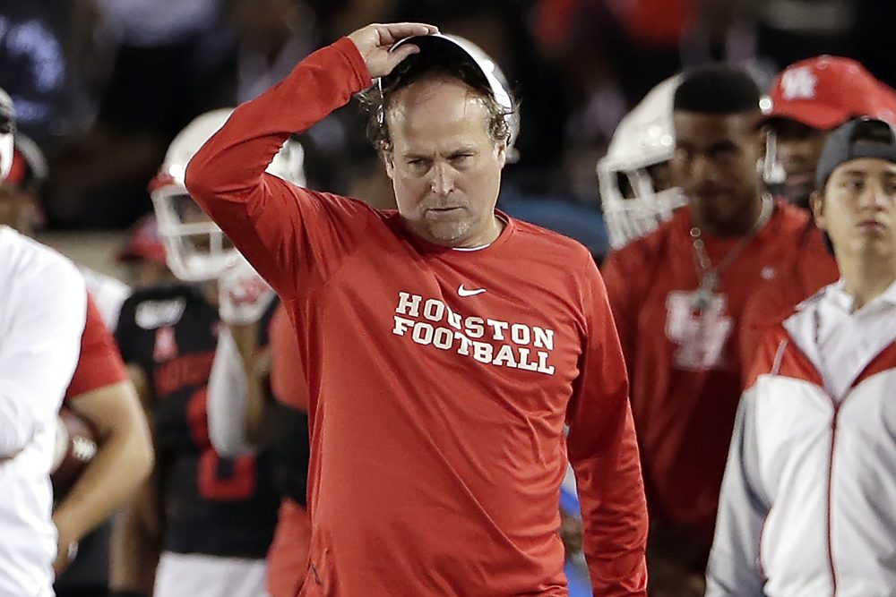 In this Oct. 24, 2019, file photo, Houston head coach Dana Holgorsen, center, reacts during the second half of an NCAA college football game against SMU, in Houston. In more than 25 years of coaching college football, Houston’s Dana Holgorsen had to deal with only two games canceled before this season. This year alone, he and the Cougars have had five games either canceled or postponed because of the pandemic, pushing their season opener back again and again.
