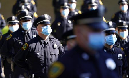 Houston Police cadets wear masks amid the COVID-19 pandemic while taking a class photo during a graduation ceremony at the Houston Police Academy, Friday, May 1, 2020, in Houston.