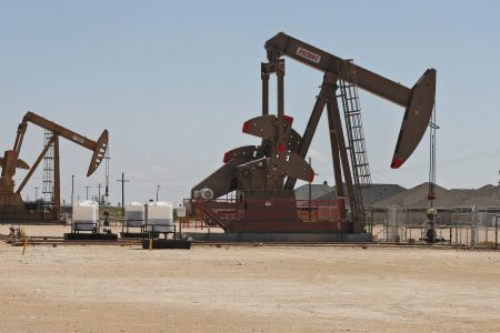 In this Monday, Sept. 2, 2019, photo, pump jacks stand next to a housing development in Odessa, Texas in the Permian Basin.