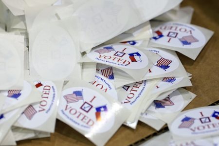 Voting stickers included in all Harris County mail-in ballots are piled in a box before being sent out to voters Tuesday, Sept. 29, 2020, in Houston. (AP Photo/David J. Phillip)