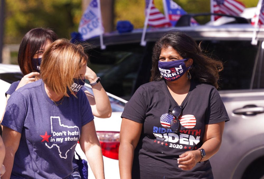 A Supporter of Democratic presidential candidate former Vice President Joe Biden chat before a Ridin' With Biden event Sunday, Oct. 11, 2020, in Plano, Texas.  Democrats in Texas are pressing Joe Biden to make a harder run at Texas with less than three weeks until Election Day.